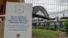 A signs adorns a security fence near the harbor foreshore ahead of New Year's Eve in Sydney, Australia, Dec. 31, 2020.