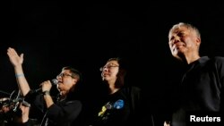 FILE - Founders of the Occupy Central civil disobedience movement, from left, Chan Kin-man, Benny Tai and Chu Yiu-ming, attend a campaign to kick off the movement in Hong Kong, Aug. 31, 2014. 