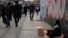 A young girl sells tissues to passersby on the Karakoy sea promenade in Istanbul, Turkey, Dec. 7, 2024.