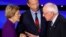 Democratic 2020 U.S. presidential candidates (L-R) Senator Elizabeth Warren (D-MA) speaks with Senator Bernie Sanders (I-VT) as billionaire activist Tom Steyer listens after the seventh Democratic 2020 presidential debate in Des Moines.