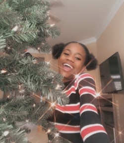 Calvina Hoff poses with the Christmas tree at her aunt’s house in Georgia. (Courtesy photo Calvina Hoff)