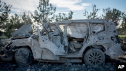 A destroyed car is seen by the house of Peshraw Dizayi that was hit in Iranian missile strikes in Irbil, Iraq, Jan. 16, 2024. Dizayi, a prominent local businessman, was killed in one of the Irbil strikes along with members of his family.