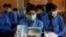 Students wearing face masks to prevent the spread of coronavirus, attend their class at a school, in Peshawar, Pakistan, Sept. 15, 2020.