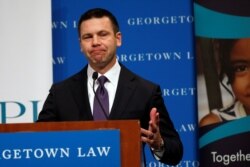 Acting Department of Homeland Security (DHS) Secretary Kevin McAleenan reacts while protesters interrupt his remarks at the Migration Policy Institute annual Immigration Law and Policy Conference in Washington, Oct. 7, 2019.