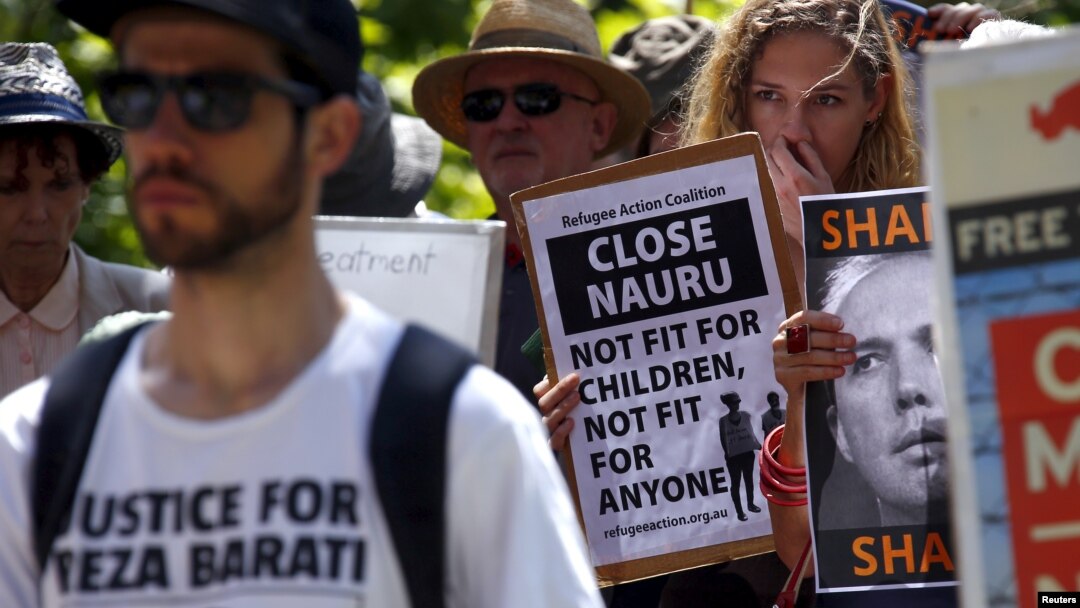 FILE - Protesters react as they hold placards and listen to speakers during a rally in support of refugees in central Sydney, Australia, Oct. 19, 2015. Australia said on April 3, 2016, it is no longer detaining asylum-seeking children on its mainland. 