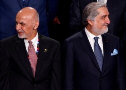 FILE - Afghanistan's President Ashraf Ghani, left, and Afghanistan's Chief Executive Abdullah Abdullah participate in a family photo at the NATO Summit in Warsaw, Poland, July 8, 2016.