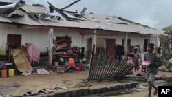 FILE - A man walks by damaged building, in Mananjary district, Madagascar, Wednesday Feb. 22, 2023 after cyclone Freddy reached Madagascar. 