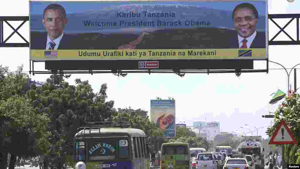A billboard with the portraits of U.S. President Barack Obama and Tanzania's President Jakaya Kikwete (R), hangs above a main street in capital Dar es Salaam, June 30, 2013.