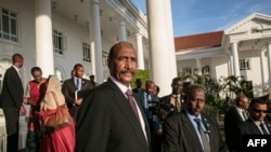 FILE - Abdel Fattah al-Burhan, then president of Sudan's Transitional Council, stands as he leaves after talks at the State House in Entebbe, Uganda, Nov. 7, 2019.