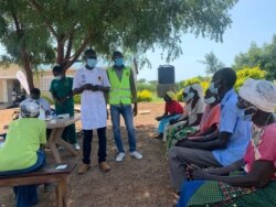 South Sudanese elders receive counseling at Swinga Health Centre 111, Yumbe district, northern Uganda, before getting the COVID-19 vaccine. (Halima Athumani/VOA)