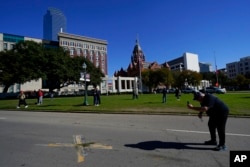 FILE - A idiosyncratic   uses a cellphone to seizure  images of an X connected  Elm Street astatine  Dealey Plaza, 1  of 2  spots marked wherever  President John F. Kennedy was shot, arsenic  radical   stitchery  connected  the 60th day  of his assassination, Nov. 22, 2023, successful  Dallas.