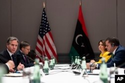 U.S. Secretary of State Antony Blinken, left, speaks as he meets with Libyan Prime Minister Abdulhamid Dbeibeh, right, at the Berlin Marriott Hotel in Berlin, Germany, June 24, 2021.