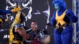 Omar Proeza, dressed as Wolverine, proposes marriage to Victoria Nauri, dressed as Beast during a Comic Con in Caracas, Venezuela, Nov. 17, 2024. 