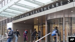 FILE - People enter New York City Health Hospitals Gouverneur Health building, Jan. 8, 2019, in New York. 