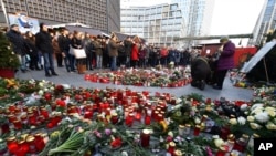 Candles and flowers to commemorate the victims of the terrorist attack on 19 December 2016 have been placed at the Christmas market near the Memorial Church in Berlin, Germany, Saturday, Dec. 31, 2016. 