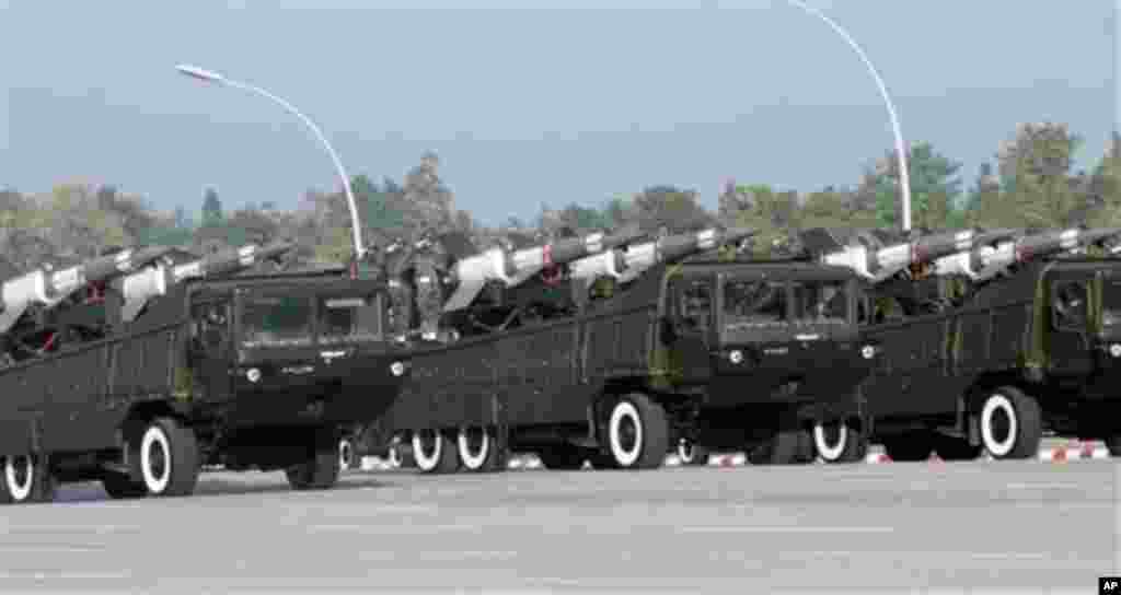 Myanmar military soldiers salute from vehicles carrying rockets as they leave the venue during a ceremony to mark the 67th anniversary of the country's Independence Day in Naypyitaw, Myanmar Sunday, Jan. 4, 2015. (AP Photo/Khin Maung Win)