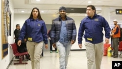 In this photo provided by the Policia de Investigacion de Chile, PDI, officers escort former heavyweight boxing champion Mike Tyson after he was denied entry to the country, at the international airport in Santiago, Chile, Nov. 9. 2017.