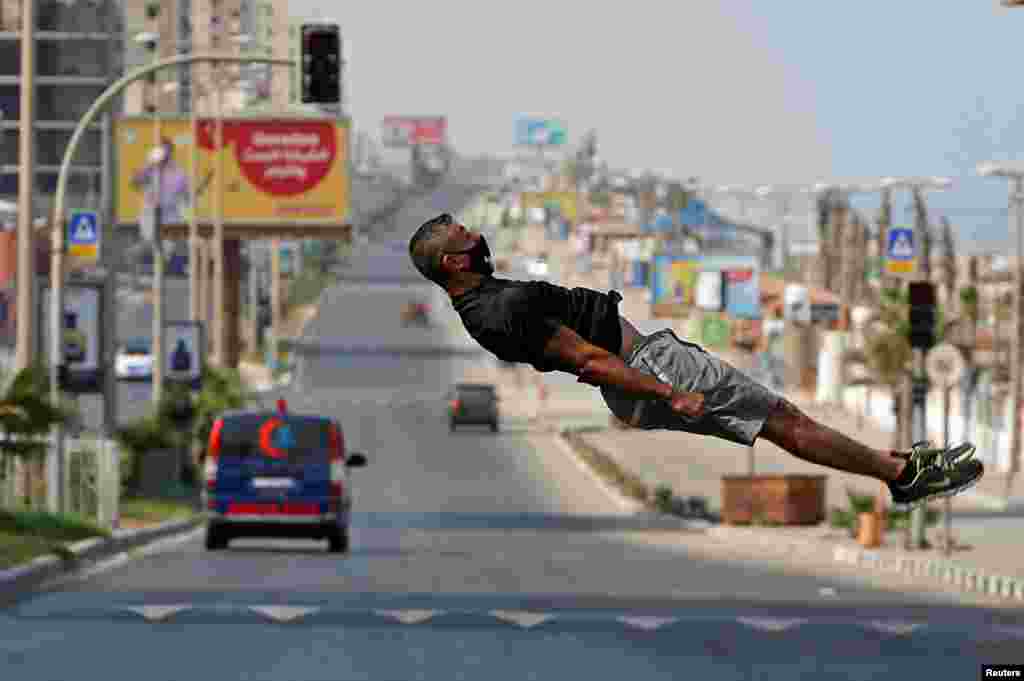 Palestinian athlete Ahmed Abu Hasira demonstrates his parkour skills during a lockdown amid the COVID-19 outbreak in Gaza City.