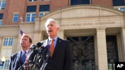 FILE - Virginia Attorney General Mark Herring, right, accompanied by Virginia Solicitor General Stuart Raphael, speaks outside the federal courthouse in Alexandria, Va., Friday, Feb. 10, 2017, following a hearing on President Donald Trump's travel ban.