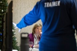 Karen Brenson Bell, from North Carolina, listens during an exercise run by military and national security officials, for state and local election officials to simulate different scenarios for the 2020 elections, Dec. 16, 2019.