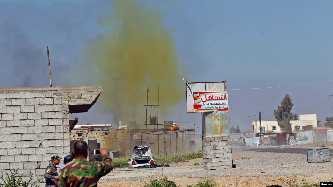 File - A chlorine-tinged cloud of smoke rises into the air from an alleged Islamic State bomb that was detonated by Iraqi army and Shi'ite fighters, in the town of al-Alam in Salahuddin province, March 10, 2015.