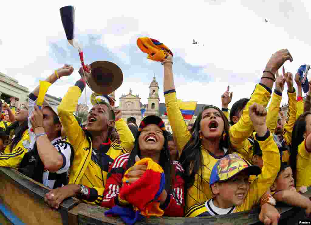 Colombia's fans celebrate their team's second goal as they watch a broadcast of the 2014 World Cup round of 16 game between Colombia and Uruguay at Bolivar Square in Bogota, June 28, 2014.
