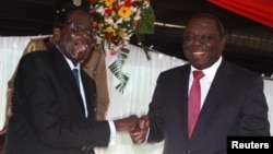 President Robert Mugabe and Prime Minister Morgan Tsvangirai at the constitution signing ceremony