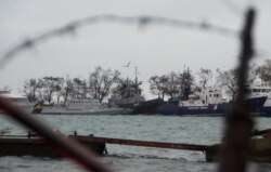 FILE - Three Ukrainian naval ships, seized three days earlier by Russian Federal Security Service (FSB) coast guard vessels, are seen anchored in a port in Kerch, in Russia-annexed Crimea, Nov. 28, 2018.