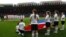 Children hold the North Korean flag ahead of the women's Group G football match between North Korea and Colombia at the London 2012 Olympic Games in Hampden Park, Glasgow, Scotland July 25, 2012.