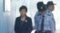 FILE - Former South Korean president Park Geun-hye, left, arrives to attend a hearing on the extension of her detention at the Seoul Central District Court in Seoul, South Korea, Oct. 10, 2017.