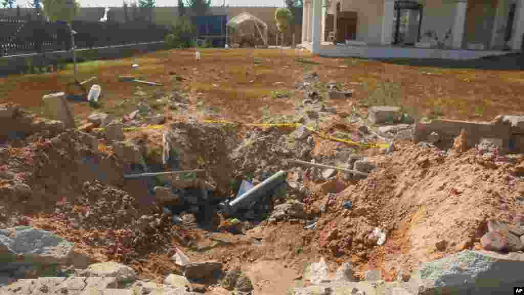 Damage is seen in the front yard of a building at the U.S. Embassy compound in Tripoli, Libya, after weeks of violence between rival militias over control of the capital, in this photo taken during a tour offered to onlookers and journalists by the Dawn o