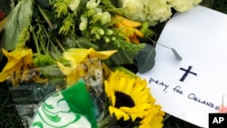 A "Pray for Orlando" card sits with part of a makeshift memorial outside the Dr. Phillips Center for the Performing Arts for victims of the fatal shootings at the Pulse Orlando nightclub in Orlando, Florida, June 13, 2016.