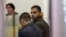 Hikmat Massarwa (R), a member of Israel's Arab minority, attends a remand hearing at the Central District Court in Lod, near Tel Aviv Apr. 25, 2013. 