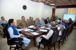 In this handout picture released by Prime Minister Office (PMO) August 7, 2019, Pakistan's Prime Minister Imran Khan (L) chairs a National Security Committee meeting in Islamabad.