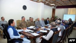 In this handout picture released by Prime Minister Office (PMO) August 7, 2019, Pakistan's Prime Minister Imran Khan (L) chairs a National Security Committee meeting in Islamabad.
