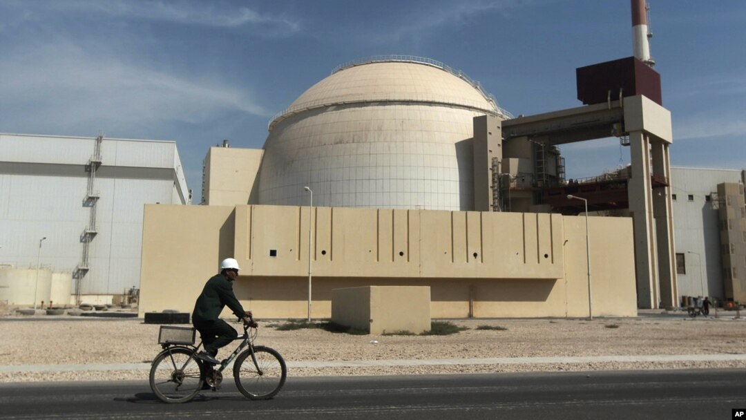 FILE: A bicyclist passes the nuclear power plant just outside Bushehr, Iran, Oct. 26, 2010. 