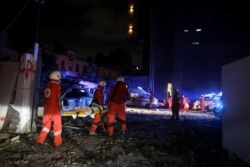 Lebanese Red Cross officers carry an injured woman following an explosion at the port of Beirut on August 4, 2020.