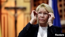 FILE - Venezuelan chief prosecutor Luisa Ortega Diaz adjusts her glasses during a meeting in defense of the Constitution in Caracas, Venezuela, Aug. 6, 2017. 