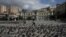 A man wearing a protective face mask makes his way on the empty Kotzia square during the COVID-19 outbreak, in Athens, Greece, on April 7, 2020. 