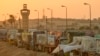 Trucks of humanitarian aids wait to cross the Rafah border crossing between Egypt and the Gaza Strip, in Rafah, Egypt, Sept. 9, 2024