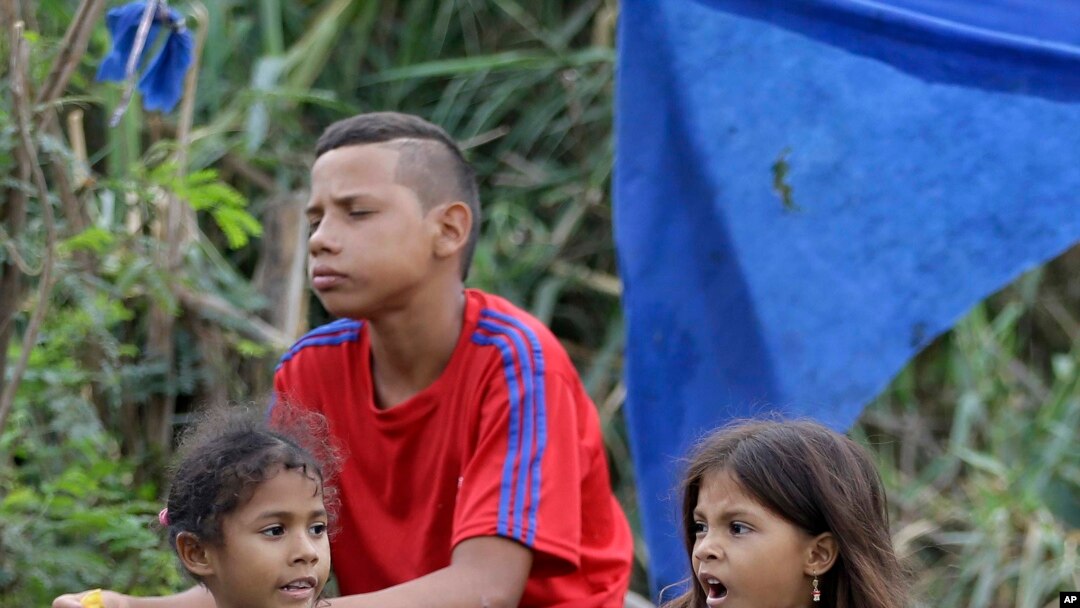 Venezuelan girls beg for change where Venezuelans cross illegally into Colombia near the Simon Bolivar International Bridge, April 14, 2019.