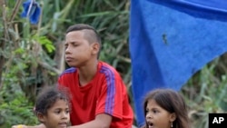 Venezuelan girls beg for change where Venezuelans cross illegally into Colombia near the Simon Bolivar International Bridge, April 14, 2019.