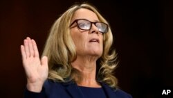 Christine Blasey Ford is sworn in before the Senate Judiciary Committee, Sept. 27, 2018 on Capitol Hill in Washington. 