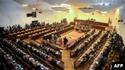 Members of Parliament of the Liberation Party of Mozambique (FRELIMO) attend the swearing in ceremony of the new Parliament at the National Assembly in Maputo, Jan. 13, 2025. 