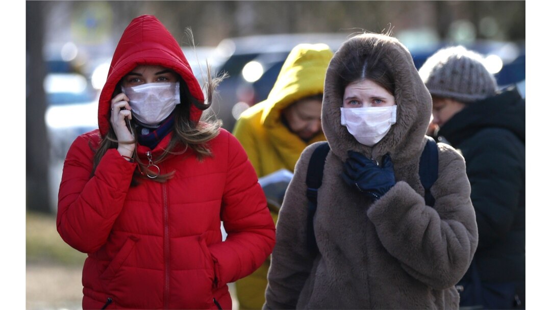 People wearing protective masks walk on street in Minsk, Belarus, Feb. 28, 2020. Azerbaijan, Belarus, Lithuania, New Zealand and Nigeria have reported their first cases of coronavirus.