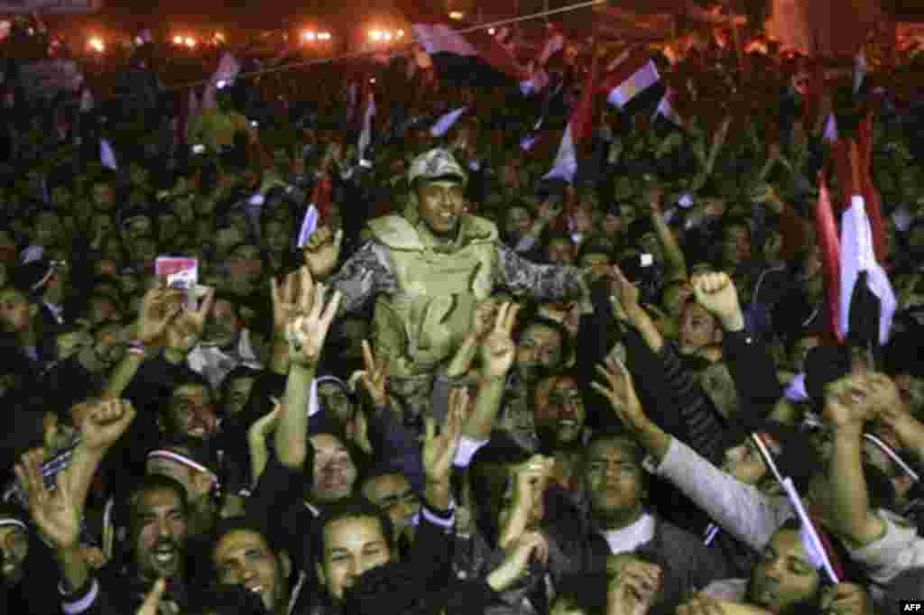 Egyptians celebrate as they carry an army soldier in Tahrir Square after President Hosni Mubarak resigned and handed power to the military in Cairo, Egypt, Friday, Feb. 11, 2011. Egypt exploded with joy, tears, and relief after pro-democracy protesters br