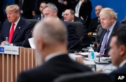 FILE - Then-U.S. President Donald Trump, then-NATO Secretary General Jens Stoltenberg, center half hidden, and then-British Prime Minister Boris Johnson, right, participate in a NATO leaders meeting in Watford, U.K., on Dec. 4, 2019.