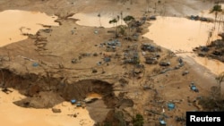 FILE- An area deforested by illegal gold mining is seen in a zone known as Mega 13, at the southern Amazon region of Madre de Dios, Jan. 25, 2014.