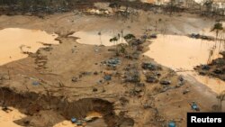 FILE- An area deforested by illegal gold mining is seen in a zone known as Mega 13, at the southern Amazon region of Madre de Dios, Jan. 25, 2014.