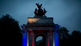 A member of the British military plays a bugle on top of the Wellington Arch before the start of two minutes of silence during a dawn service to mark the 99th Anzac Day on Hyde Park Corner in London.